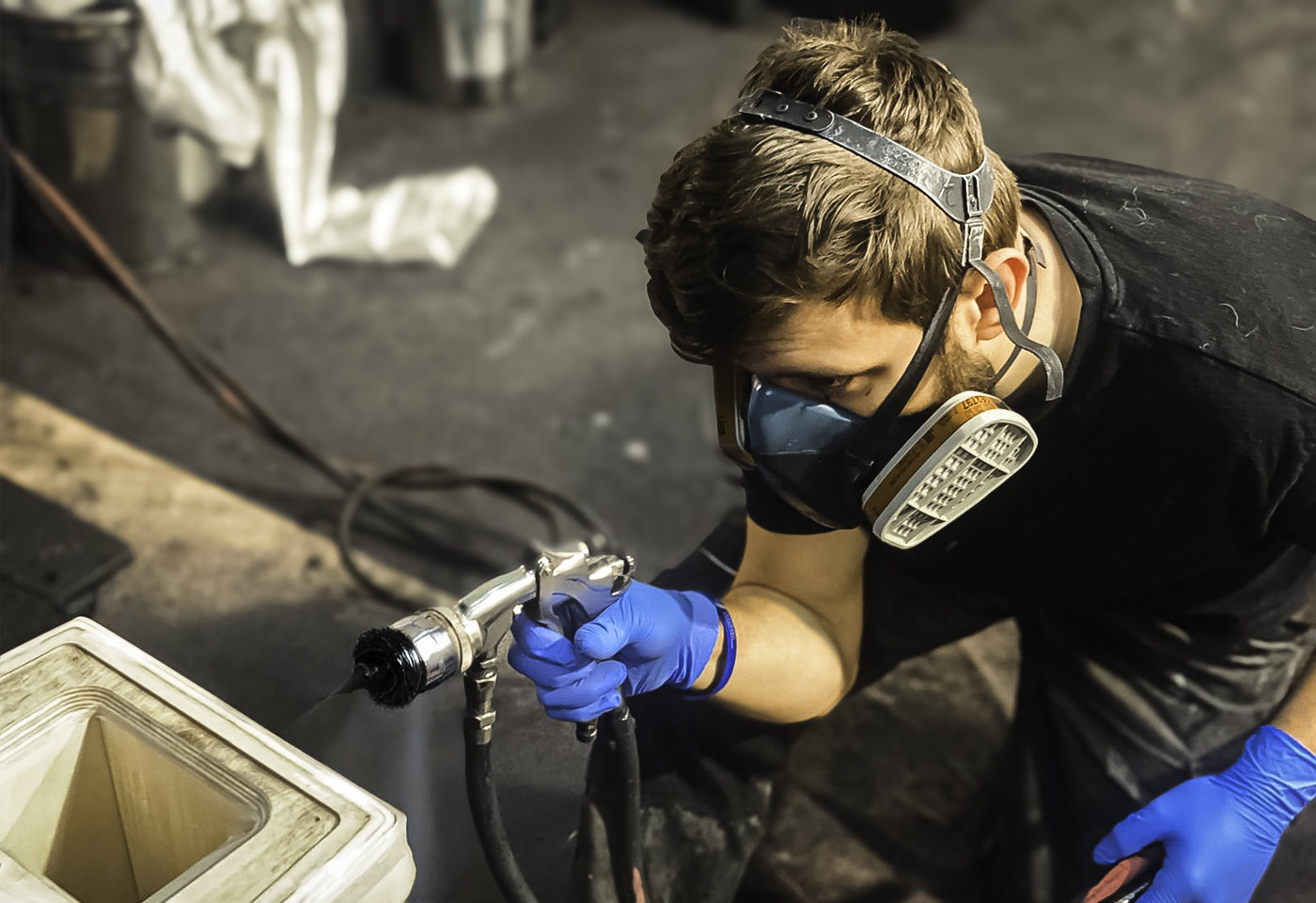 A speaker cabinet being spray-finished in the Sarivale spray shop.