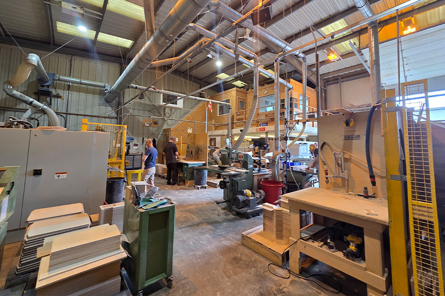 The Sarivale workshop floor in Calne with team members at work on cabinet assembly.